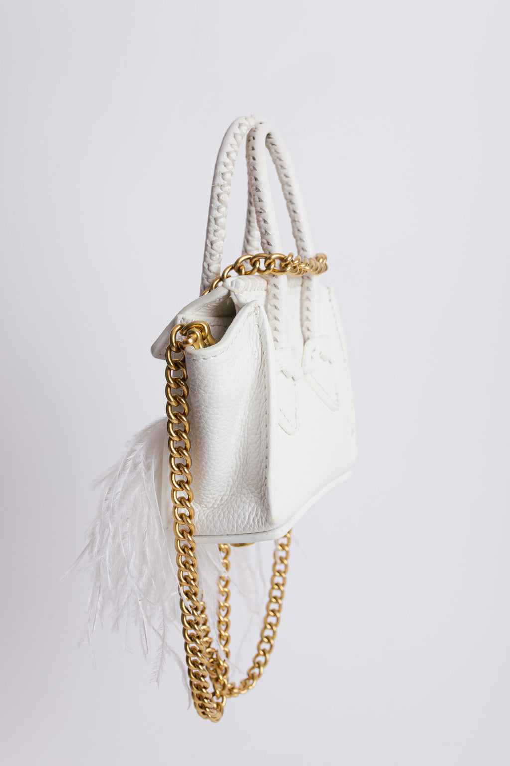 La bebe in white with feathers