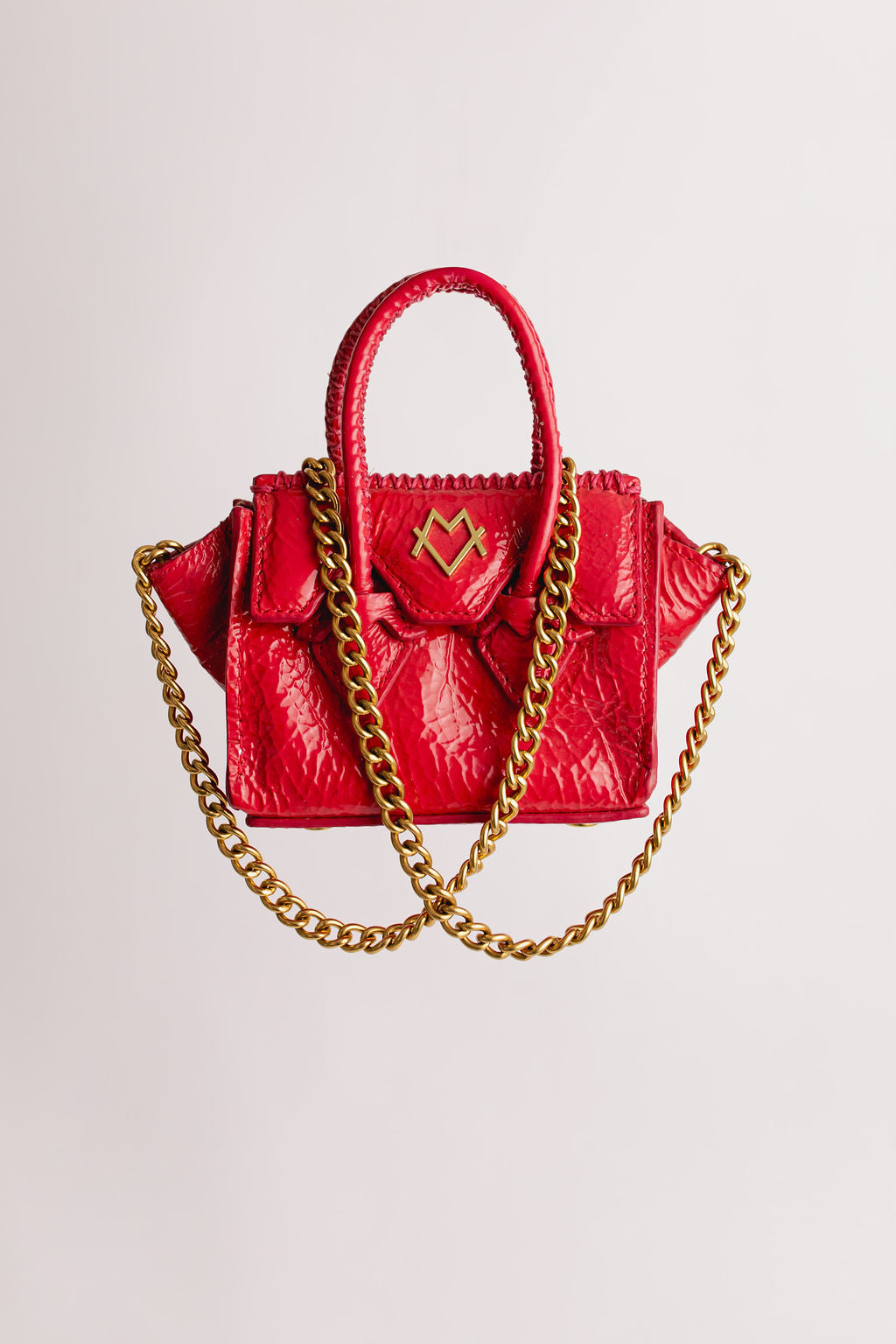 La Bébé en cuir verni fuchsia