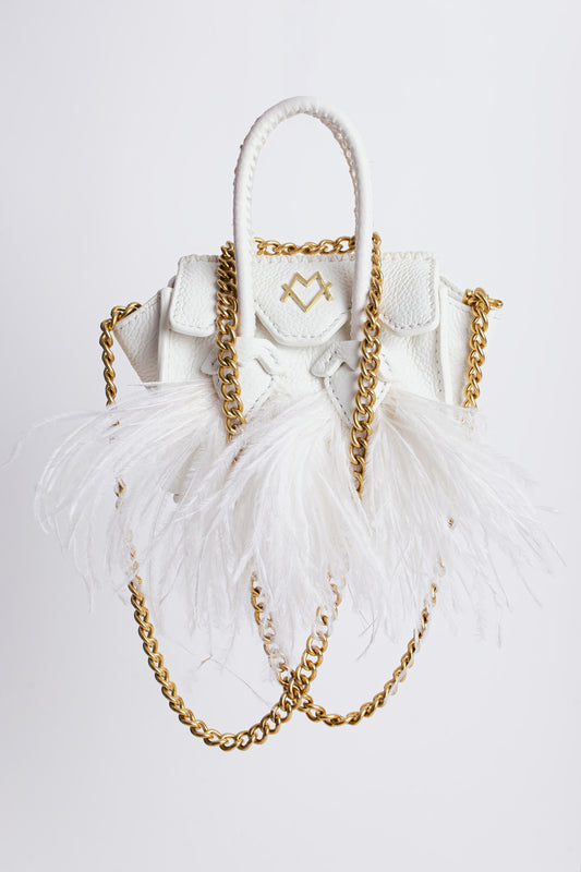 La bebe in white with feathers