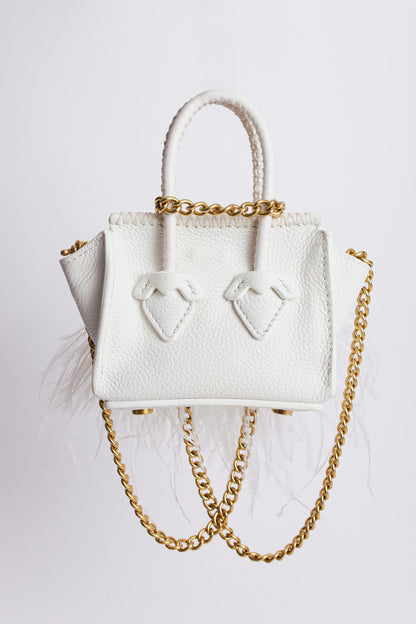 La bebe in white with feathers