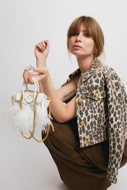 La bebe in white with feathers